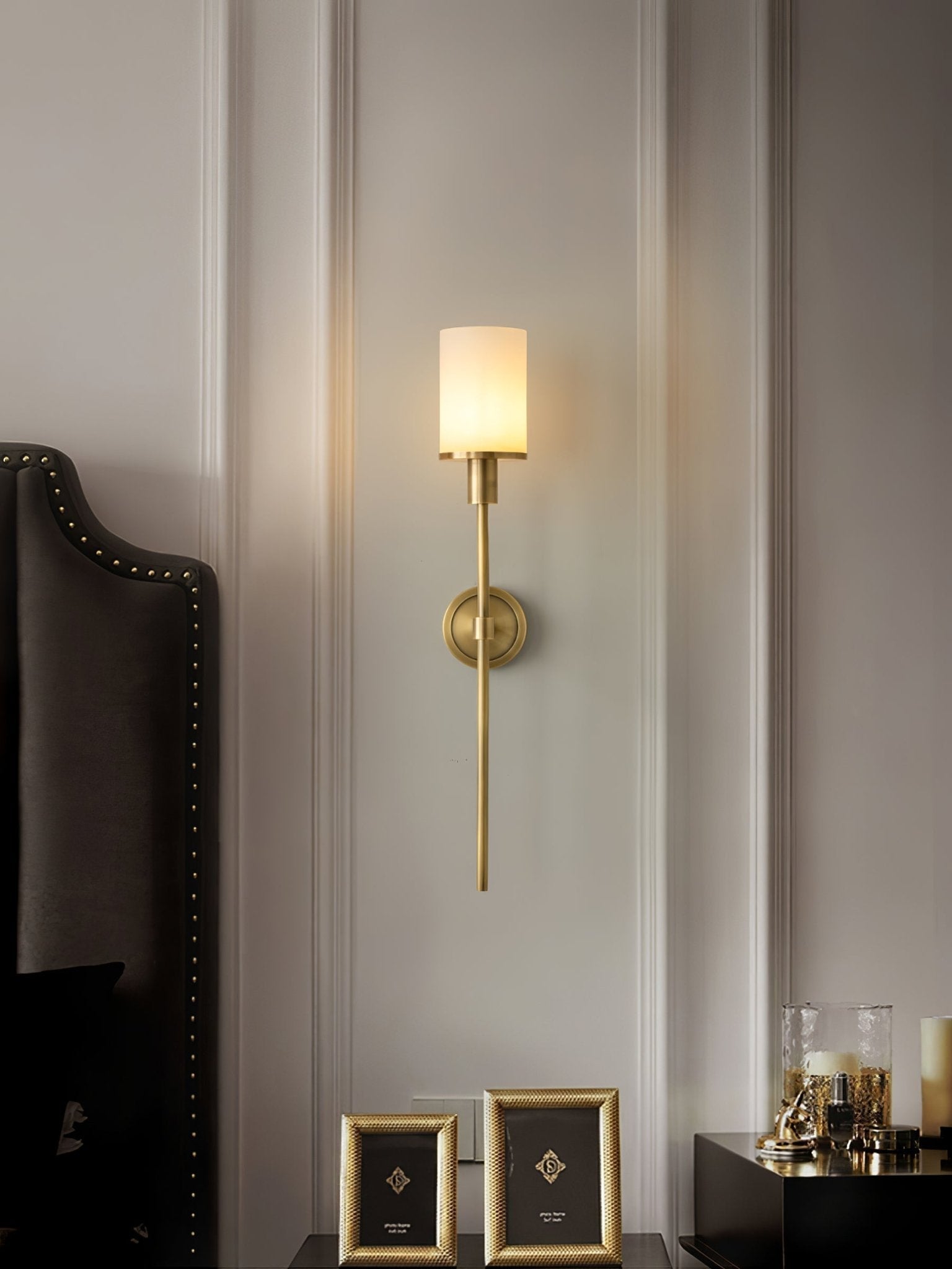 Clérachic Mycara in copper above a dark studded headboard, alabaster shade lit beside gilt bedside frames.