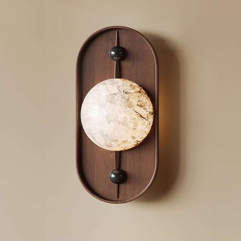 The Clérachic orb shows cool white and gold veining running across the stone, framed by its dark walnut plate.