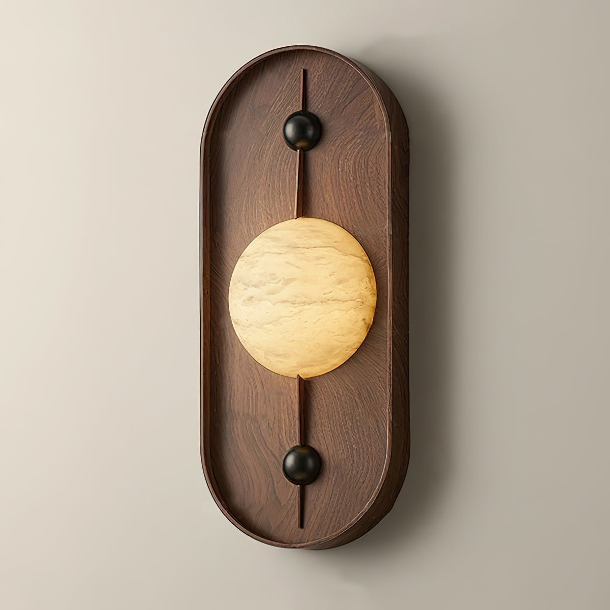 Clérachic throws a soft halo up and down the walnut back plate and onto the pale wall behind the lit orb.