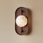 The Clérachic orb in close view, genuine alabaster with grey and gold seams running through the polished stone.