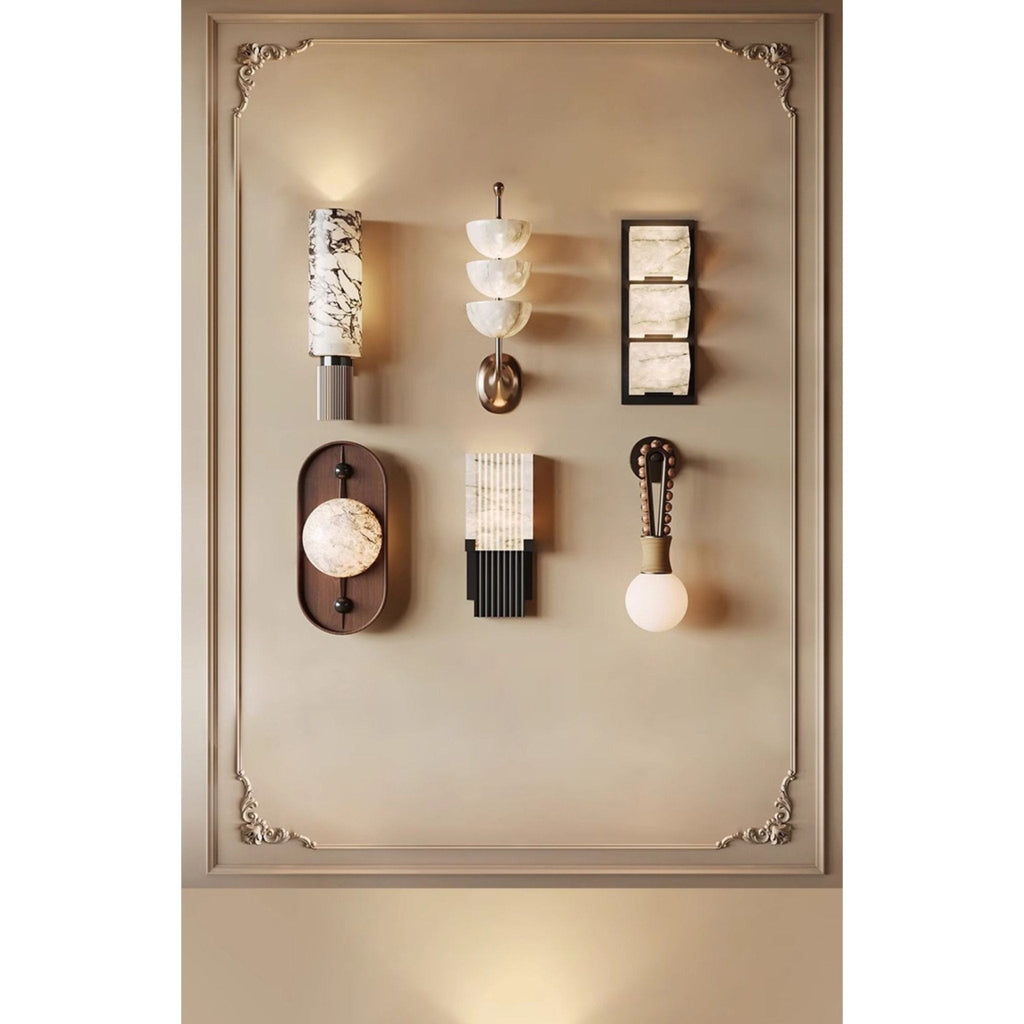The Clérachic oval sconce on a showroom wall, grouped with other fixtures that give a sense of its scale.