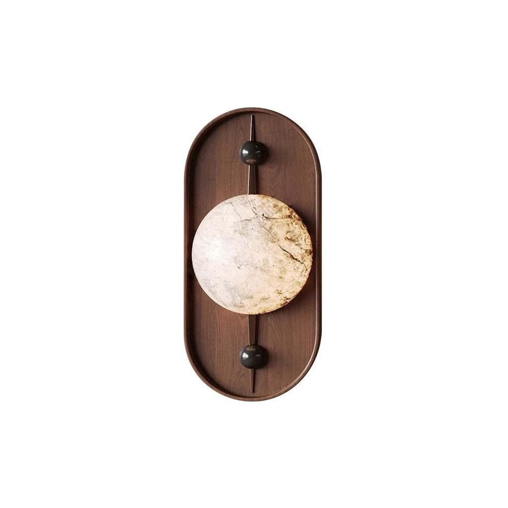 Clérachic shot flat on white: walnut oval, black end caps and a heavily veined alabaster orb at the centre.
