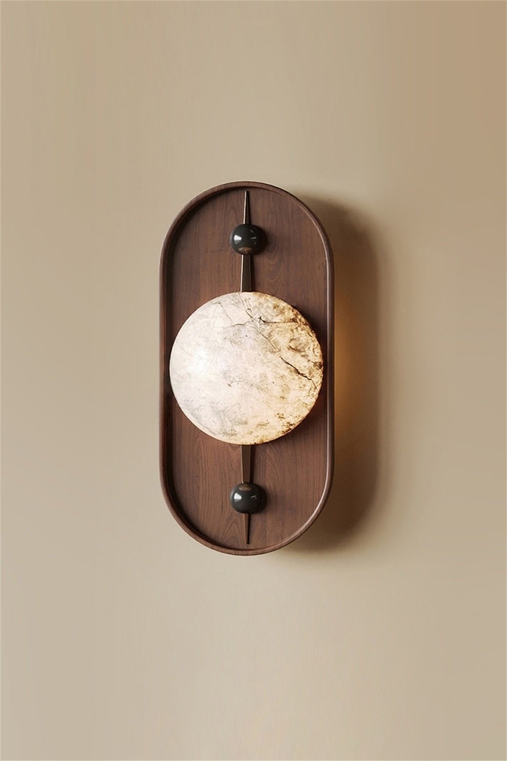 The Clérachic orb reads as a polished stone disc pinned through the wooden oval against a warm beige wall.