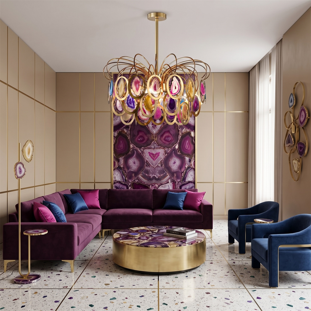 A Clérachic agate chandelier centred above a plum velvet corner sofa and a round gold coffee table in a cream panelled room.
