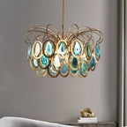Clérachic blue agate chandelier on a long gold stem against a grey wall, with a small ornament on a console beneath it.