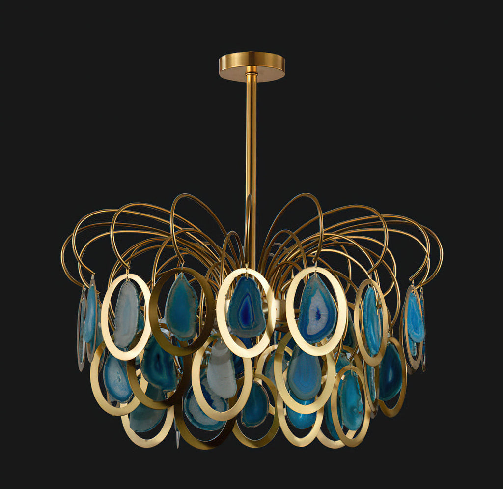 Closer view of the blue version of this Clérachic chandelier on black, showing the gold rings and the teal agate slices.