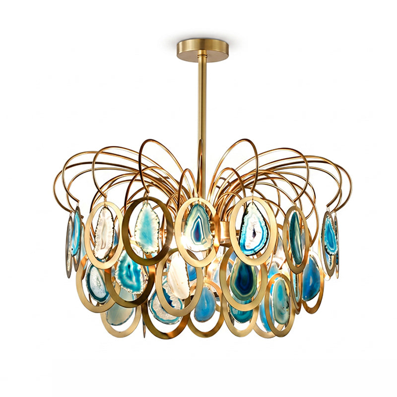 Closer view of the blue Clérachic agate chandelier, with teal slices in gold rings below looping brass wires, on white.