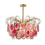 Closer view of the pink Clérachic agate chandelier, with deep rose and magenta slices in gold rings, on white.