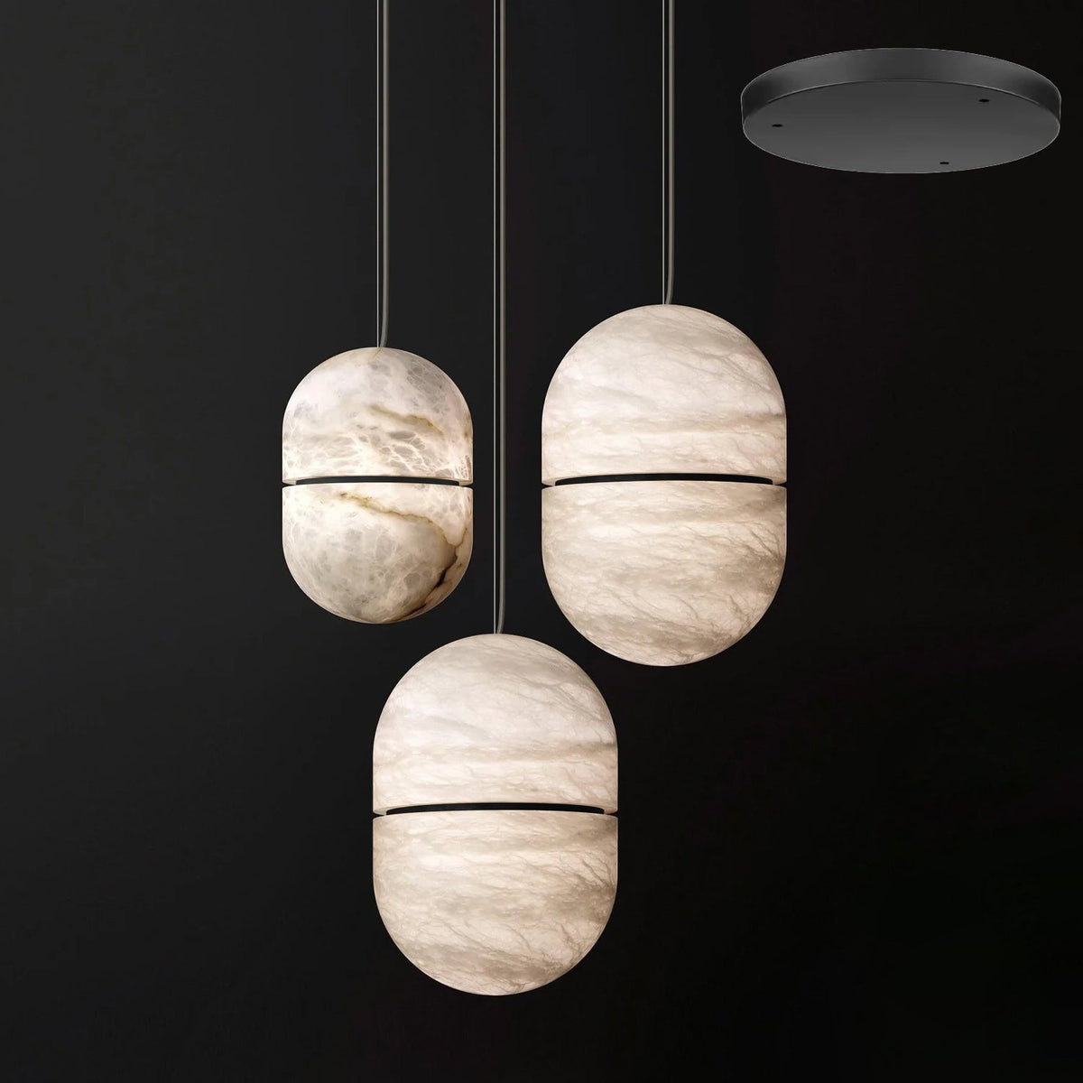 Three Clérachic alabaster pendants with dark bands, hung at different heights from a black round canopy.