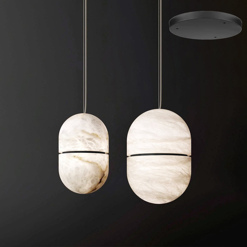 Two Clérachic alabaster pendants with dark bands beside each other on a dark backdrop, with a black canopy shown top right.