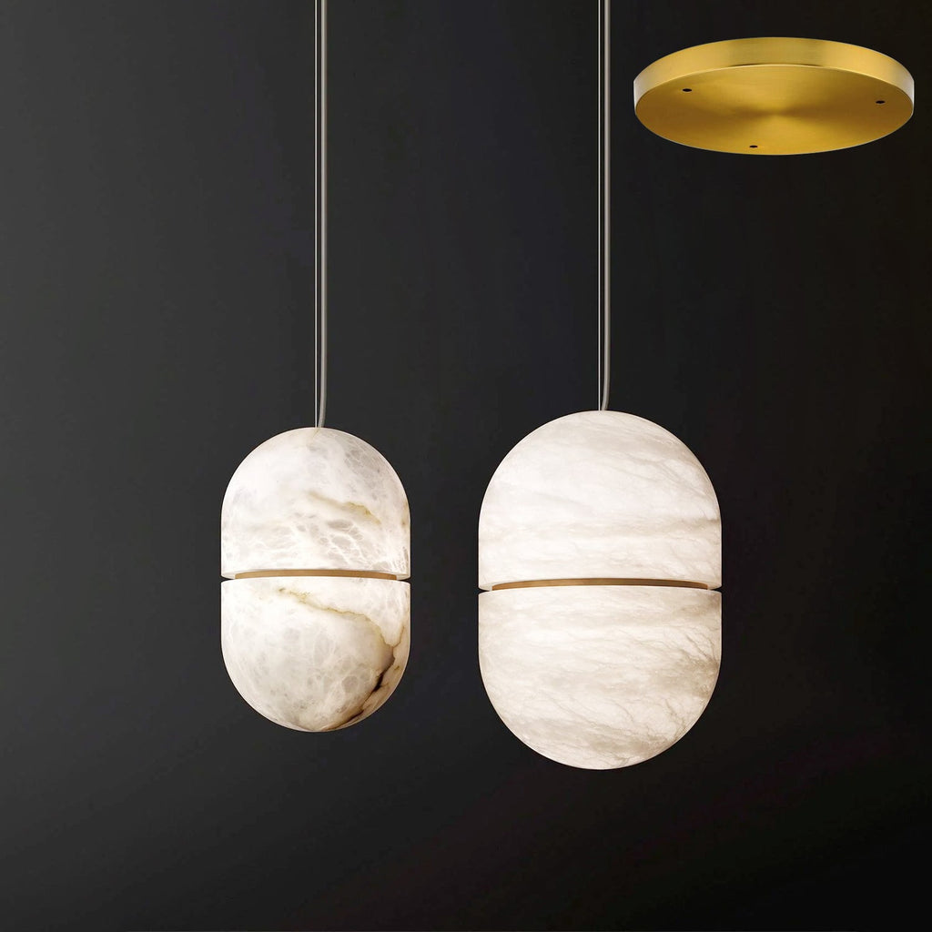 Two Clérachic alabaster pendants with gold bands and a gold round canopy at the top right, on a dark backdrop.