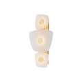 Clérachic natural alabaster wall sconce lit on a white background, three stone plates each pinned by a solid brass disc.