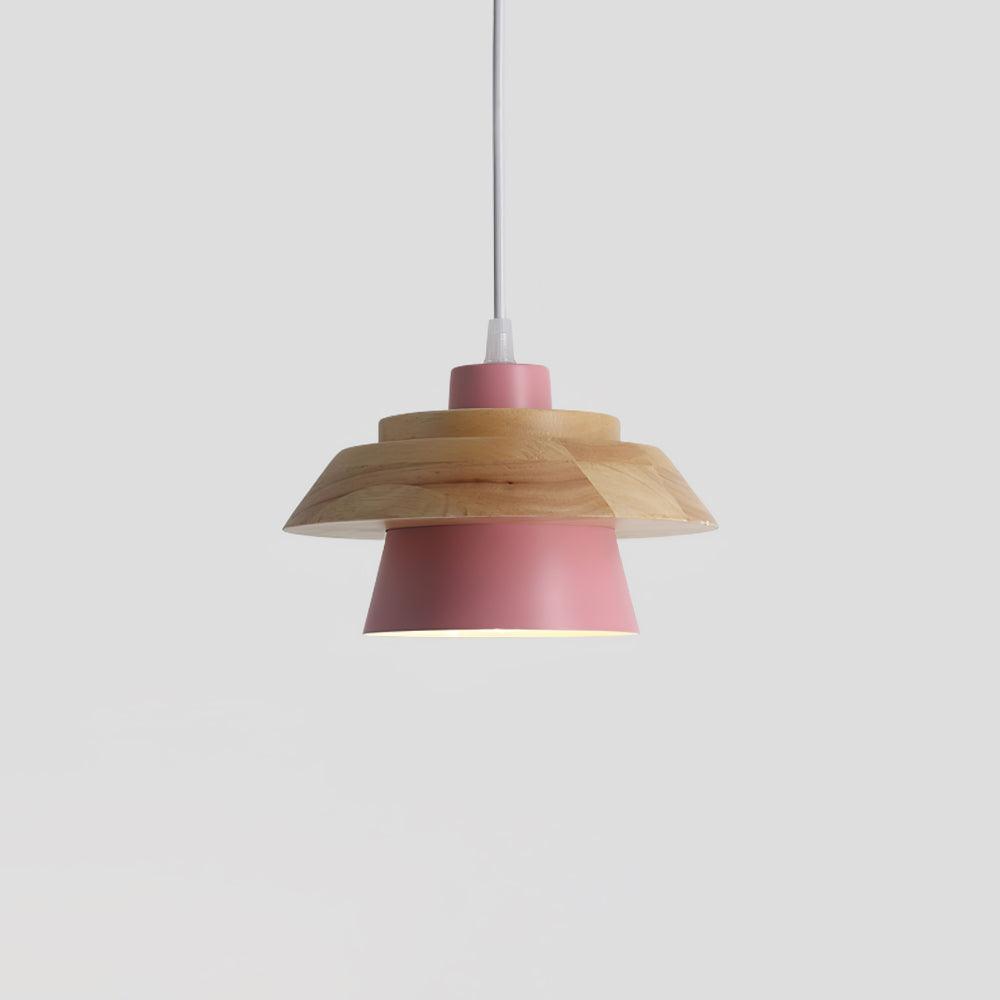 Pink metal shade under a layered natural wood top and a white cord, on a plain pale grey backdrop, from Clérachic.