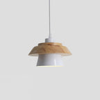 White metal shade under a layered natural wood top, hung from a white cord, on a plain pale backdrop, from Clérachic.