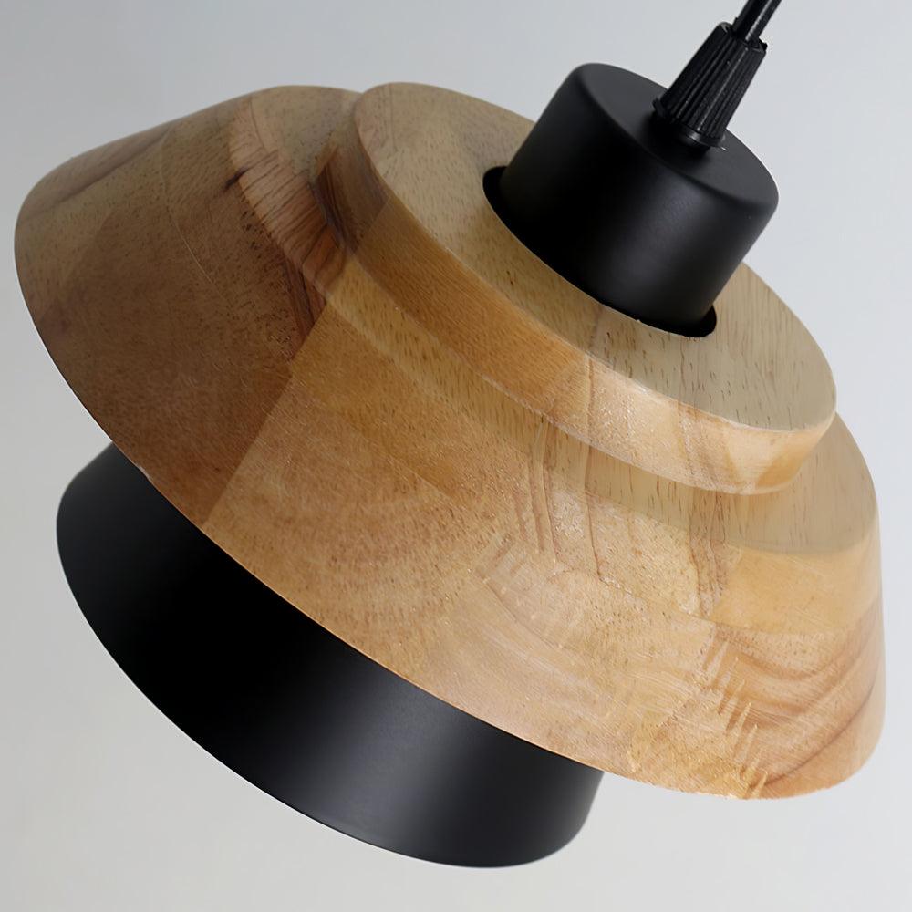 Close view of the layered wood top and black metal shade on this Clérachic pendant, with its black fitting above.