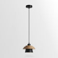 Black-shaded Clérachic pendant with a layered wood top and a round black ceiling canopy, on a plain light backdrop.