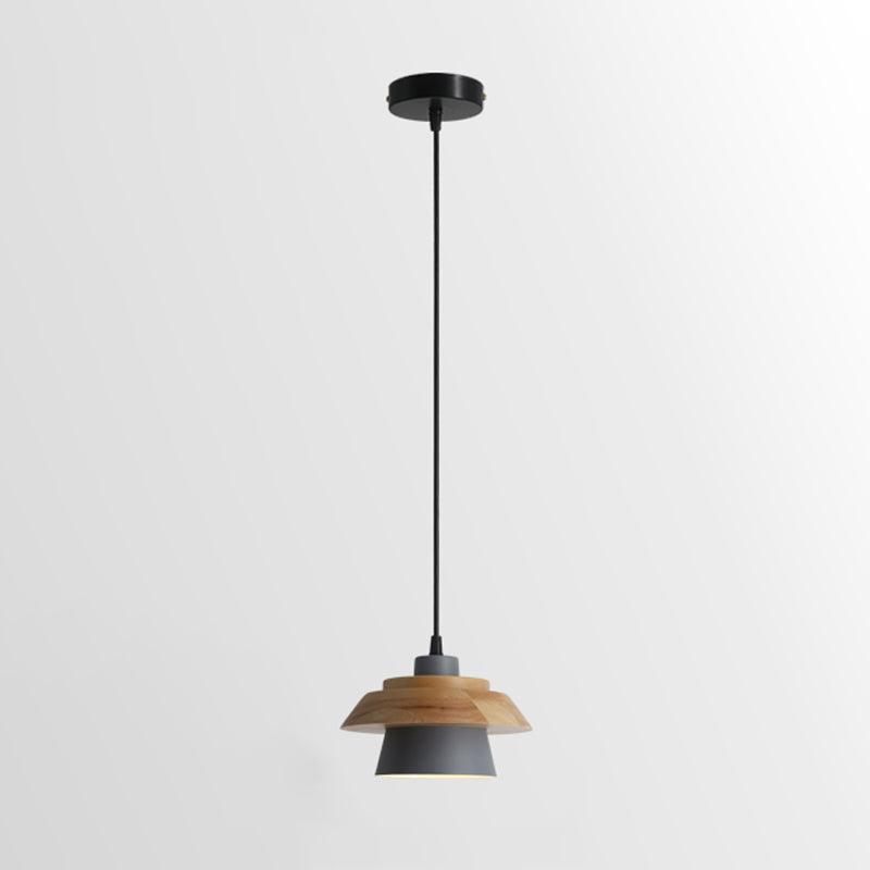 Grey-shaded Clérachic pendant with a layered wood top on a black cord and round black canopy, on a soft grey backdrop.