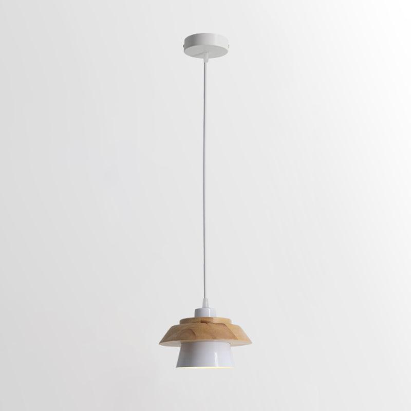 White-shaded Clérachic pendant with a layered wood top, on a white cord and a round white canopy, on a pale backdrop.
