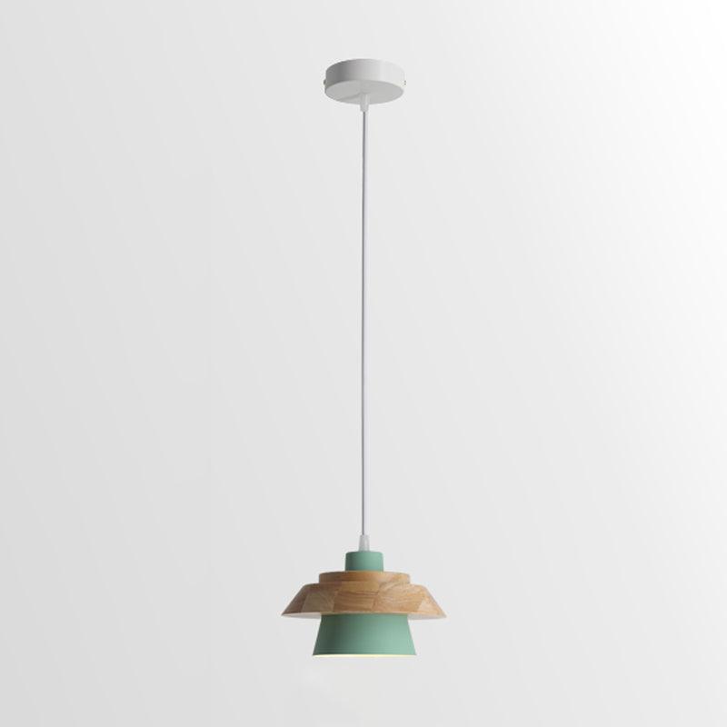 Green-shaded Clérachic pendant with a layered wood top, on a white cord and a round white canopy, on a pale backdrop.
