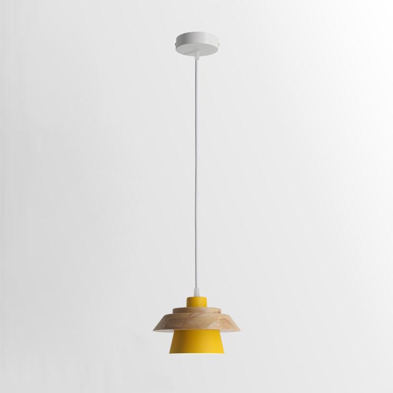 Yellow-shaded Clérachic pendant with a wood top, on a white cord and a round white canopy, on a pale backdrop.
