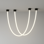 Clérachic black-capped flexible LED chandelier loops in two glowing white arcs from a plaster ceiling corner.