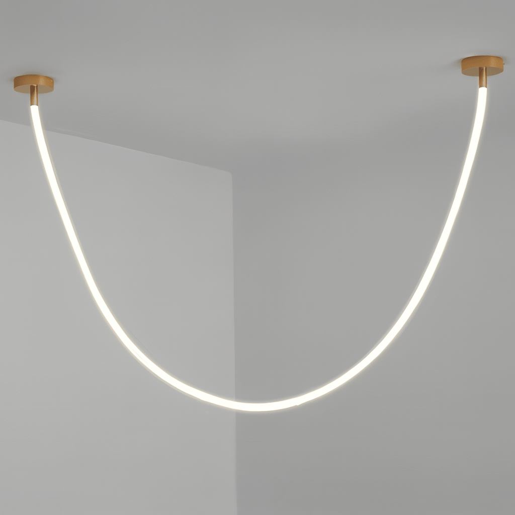 Clérachic gold-capped flexible LED chandelier drops in one glowing white loop against a plain grey corner.