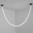 Clérachic black-capped flexible LED chandelier drops in one glowing white loop against a plain grey corner.