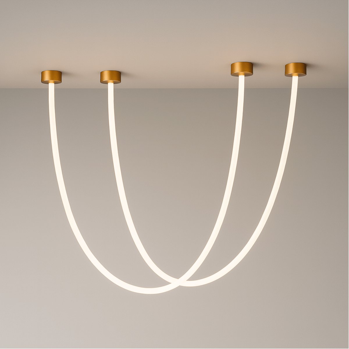 Clérachic gold-capped flexible LED chandelier arcs in three glowing loops of different lengths on a grey wall.