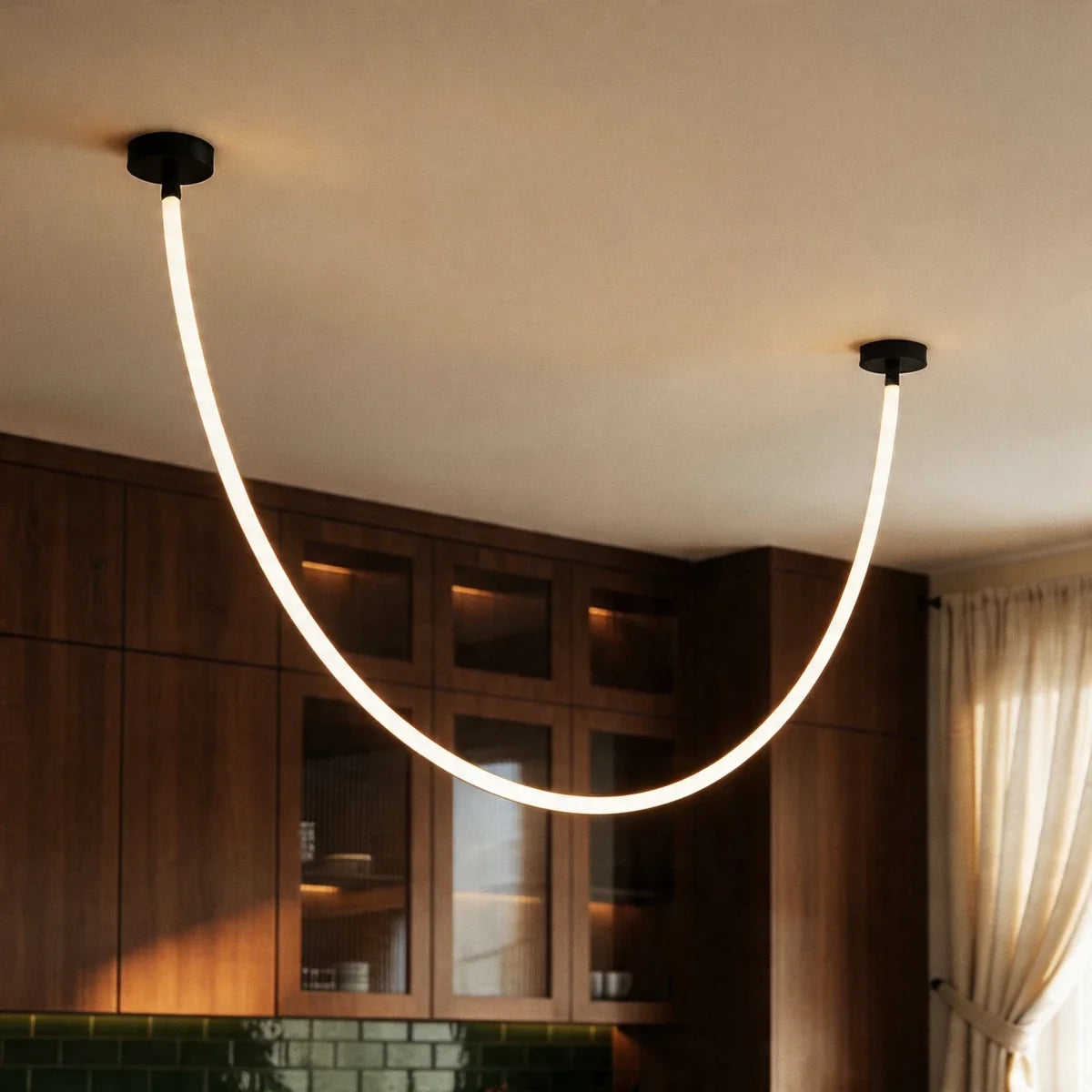 Close view of the Clérachic black-capped flexible LED chandelier looping past walnut glass-front cabinetry.