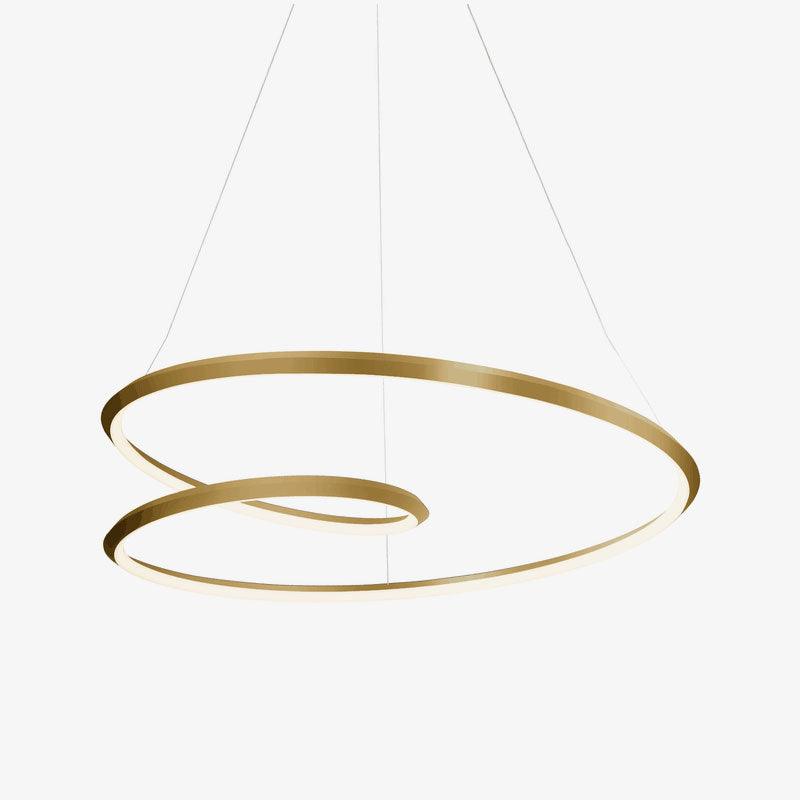 A gold Clérachic spiral ring chandelier on a pale grey backdrop, the brushed metal catching light along the outer edge.