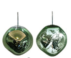 The Clérachic melt pendant in green, mirrored finish beside its lit translucent form.