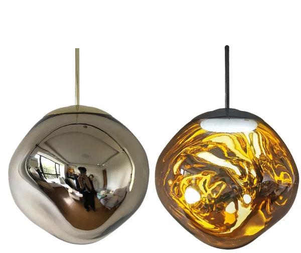 Clérachic melt pendant in gold, mirrored outside and glowing amber when lit.