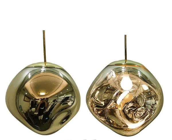 The Clérachic melt pendant in brass, shown mirrored and lit side by side.