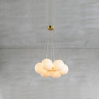The Clérachic Norduvyd in its smallest form, stone spheres packed tight and lit warm beneath a brass ceiling plate.