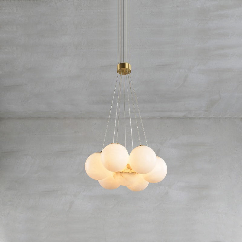 The Clérachic Norduvyd in its smallest form, stone spheres packed tight and lit warm beneath a brass ceiling plate.