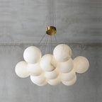 Clérachic photographs the Norduvyd unlit in daylight, the stone globes reading flat matte white on grey plaster.