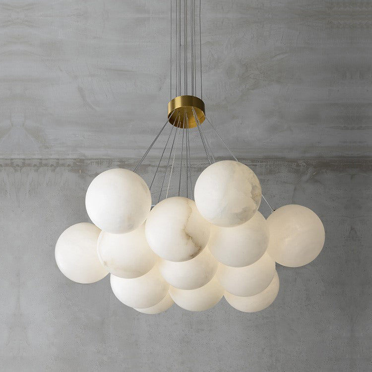 Clérachic photographs the Norduvyd unlit in daylight, the stone globes reading flat matte white on grey plaster.