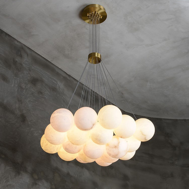 The Clérachic Norduvyd shot from beneath a curved concrete wall, its lit globes warming to a soft blush tone.