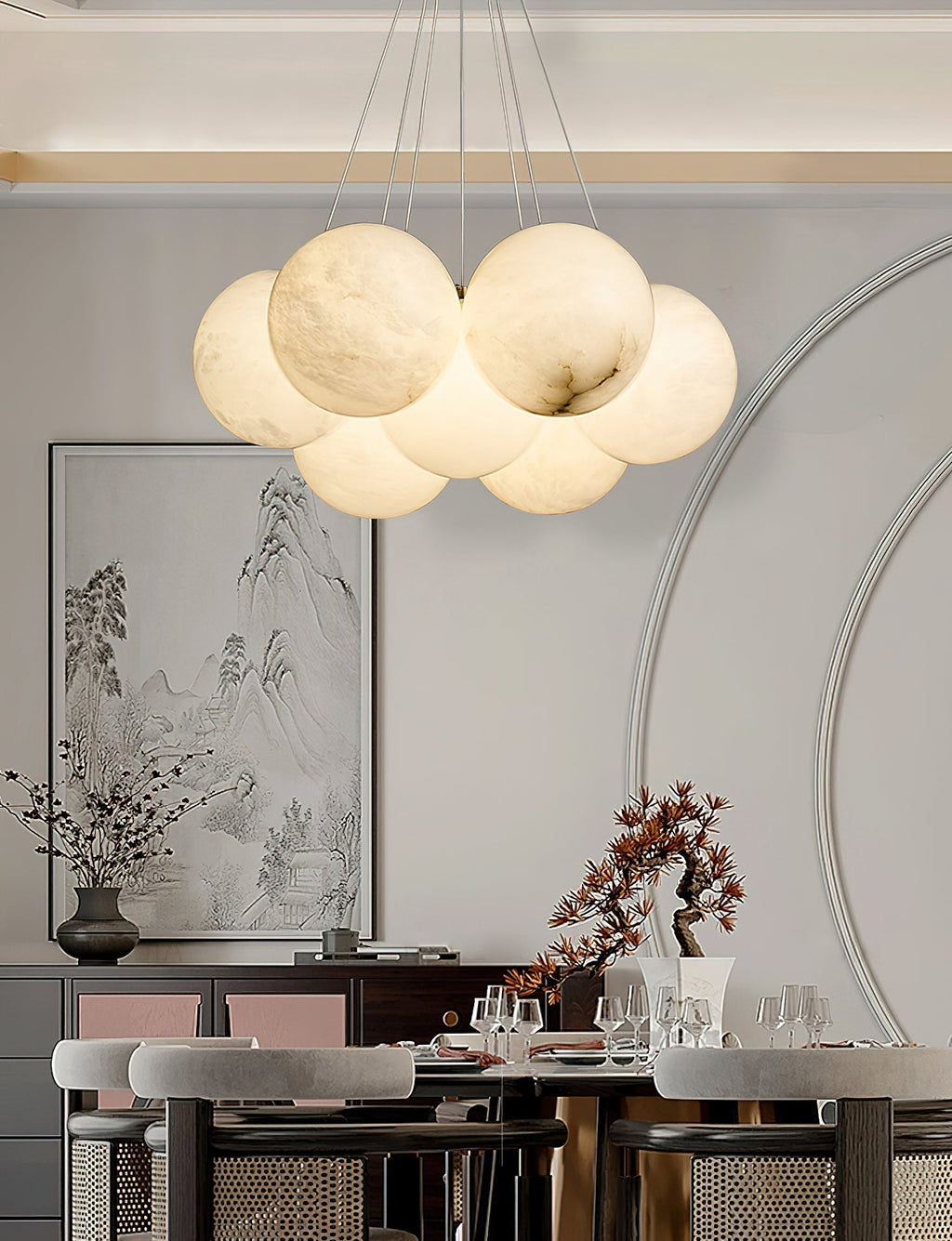 The Clérachic Norduvyd hangs over a dining table in a room with an arched screen and a framed ink landscape.