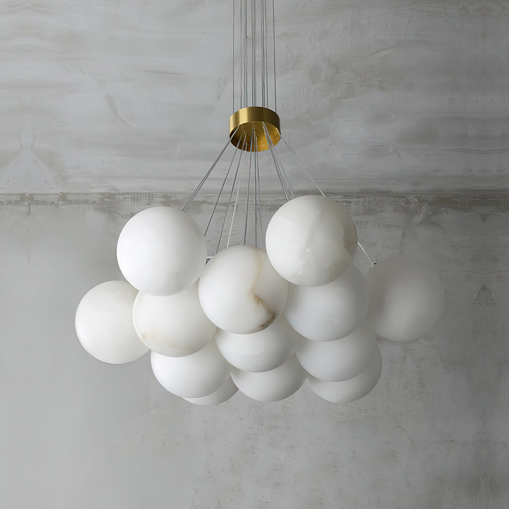 The Clérachic Norduvyd unlit from below, each alabaster globe hung at its own height on a clear suspension wire.