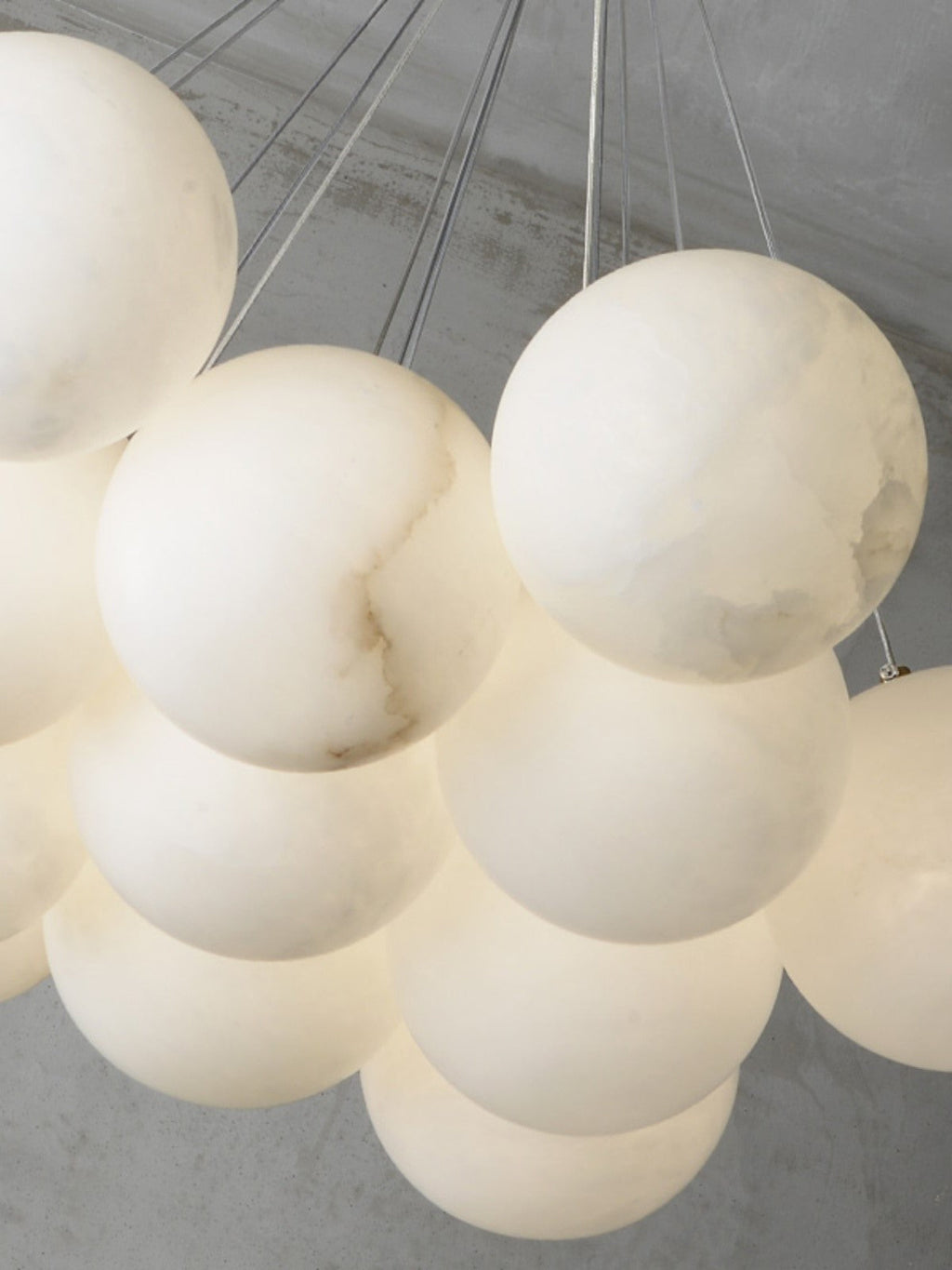 Clérachic in tight close-up on a lit Norduvyd cluster, warm light glowing through the translucent stone globes.