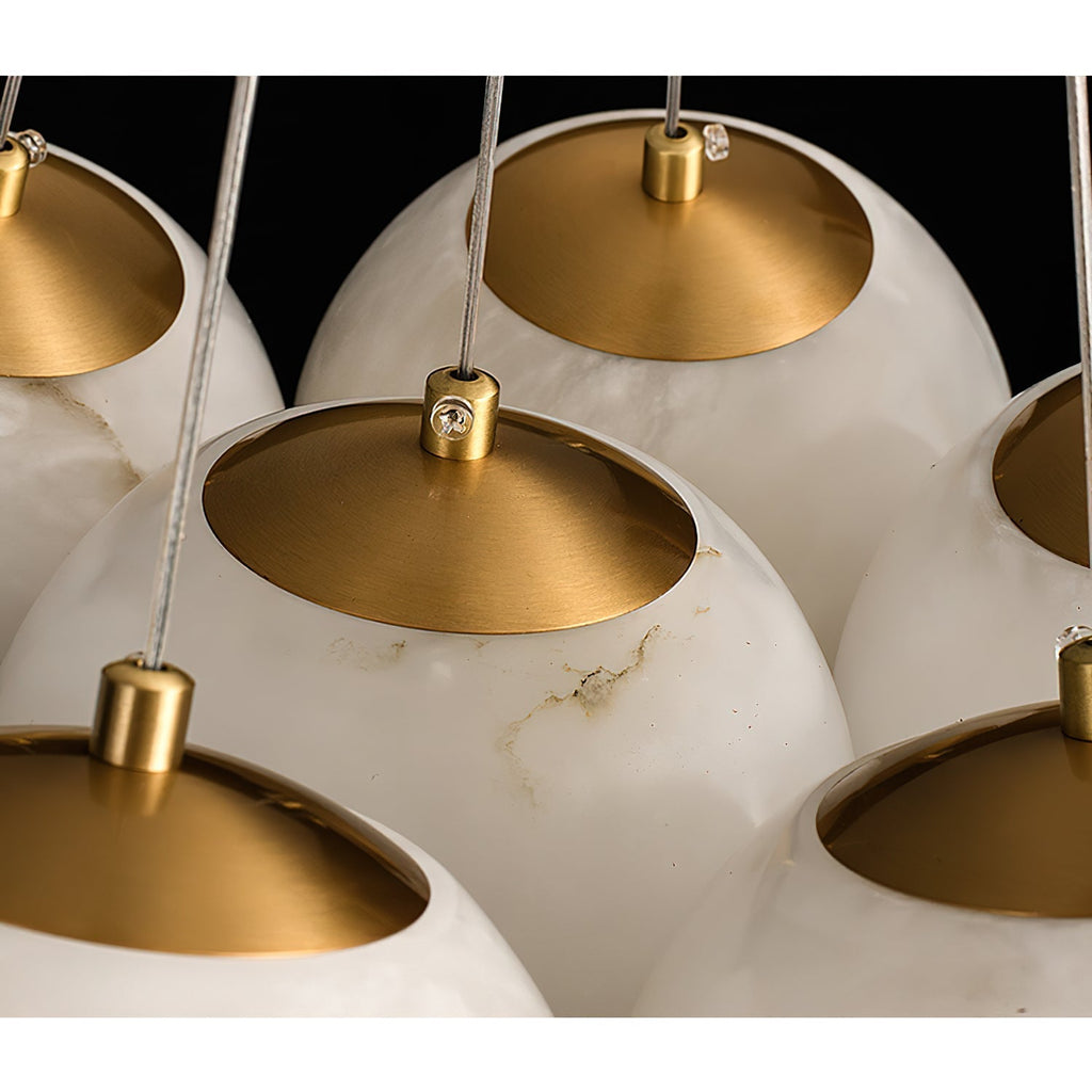 The Clérachic Norduvyd close up on the brushed brass reflector cups seated on top of each alabaster globe.