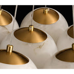 The Clérachic Norduvyd close up on the brushed brass reflector cups seated on top of each alabaster globe.