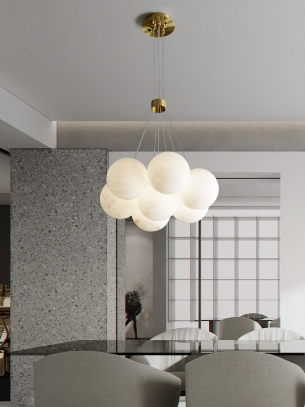 Clérachic drops the Norduvyd in a bright dining room, its globes silhouetted against tall windows and terrazzo.