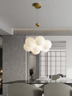 Clérachic drops the Norduvyd in a bright dining room, its globes silhouetted against tall windows and terrazzo.