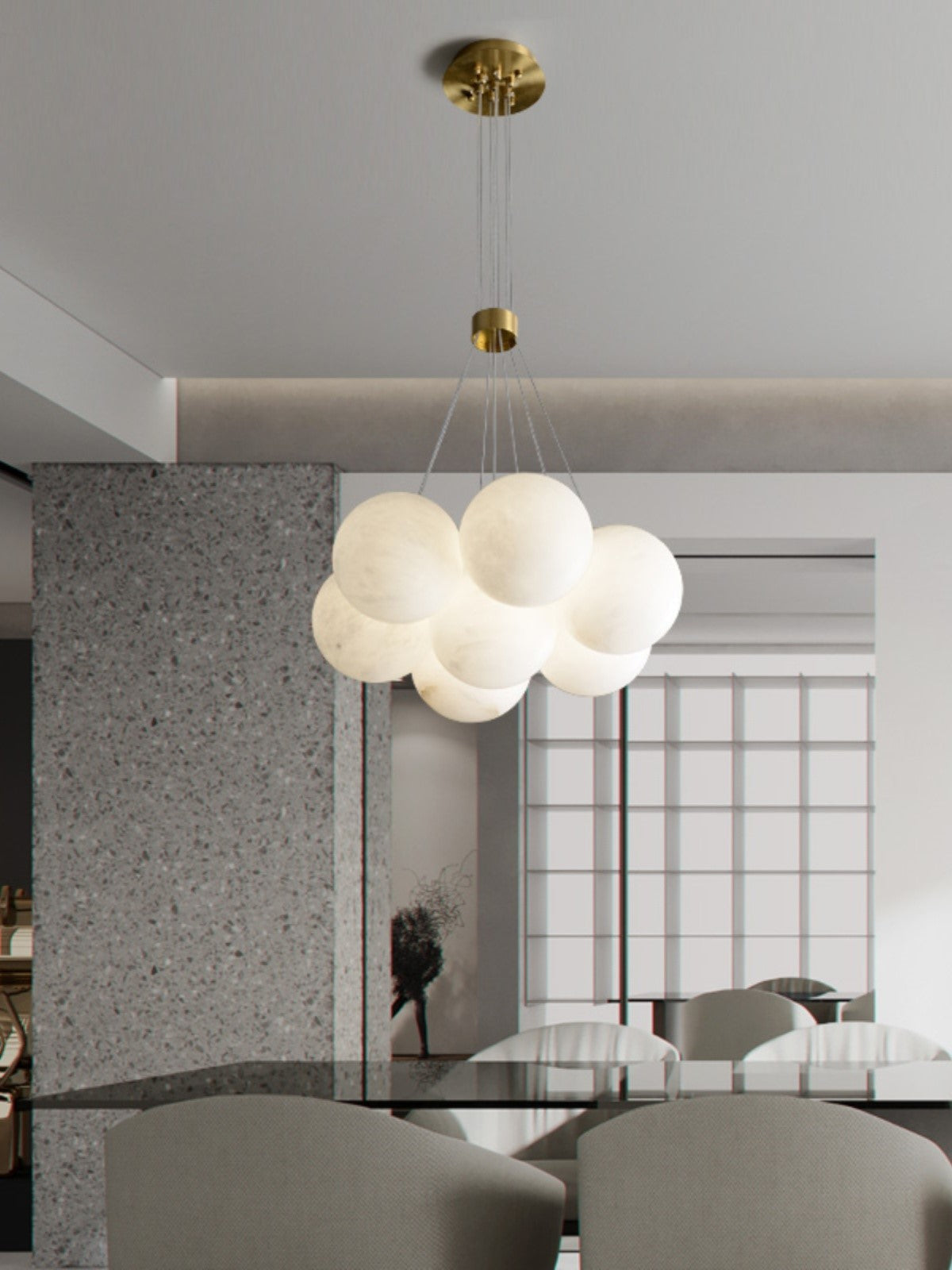 Clérachic drops the Norduvyd in a bright dining room, its globes silhouetted against tall windows and terrazzo.
