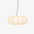Clérachic oblate silk pendant light lit against a plain white background, its wide lobed shade hung from a slim ceiling cord.