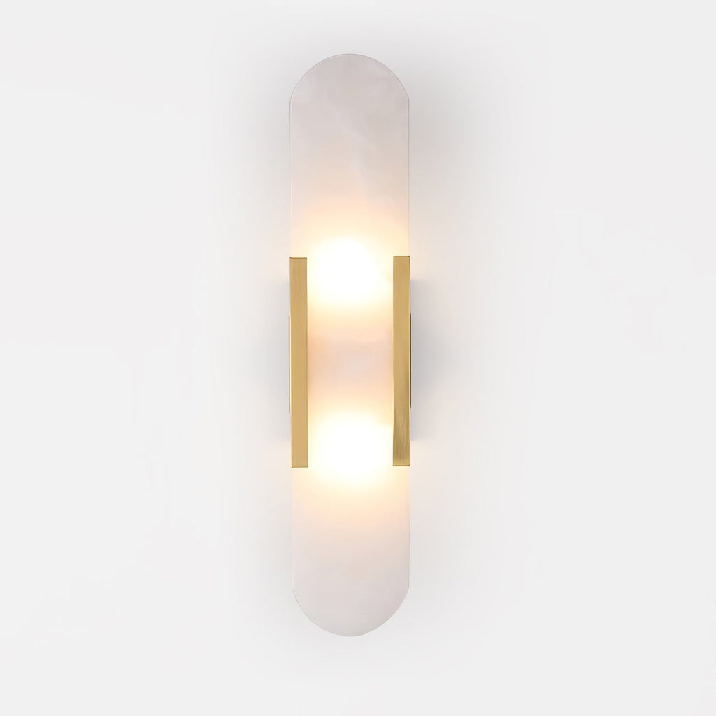 Clérachic Olraeia sconce head-on in brass on white, warm light pooling above and below the stone panel