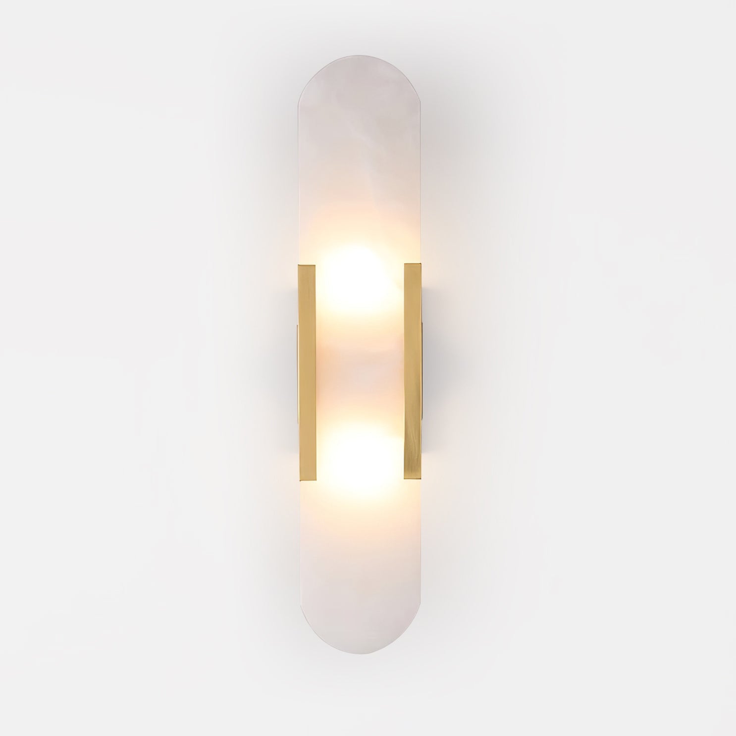 Clérachic Olraeia sconce head-on in brass on white, warm light pooling above and below the stone panel