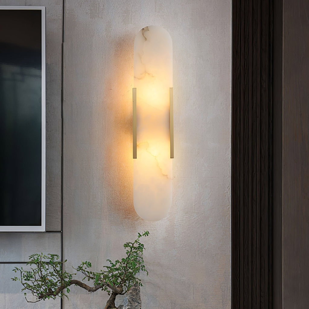 Clérachic sconce glowing on a textured plaster wall next to dark timber panelling, a bonsai below
